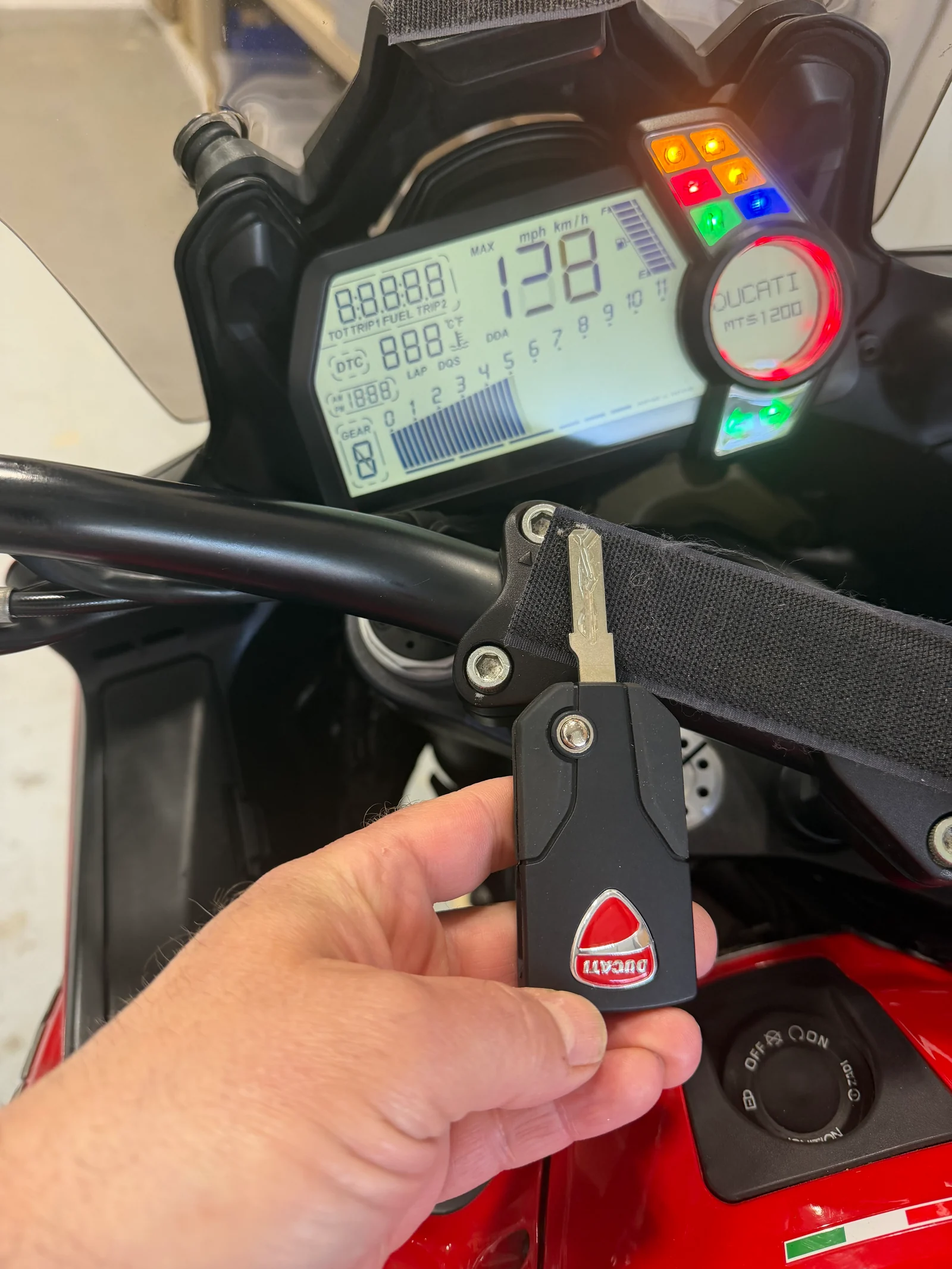 Freshly programmed Ducati Multistrada 1200 flip key in front of the MTS 1200 dashboard